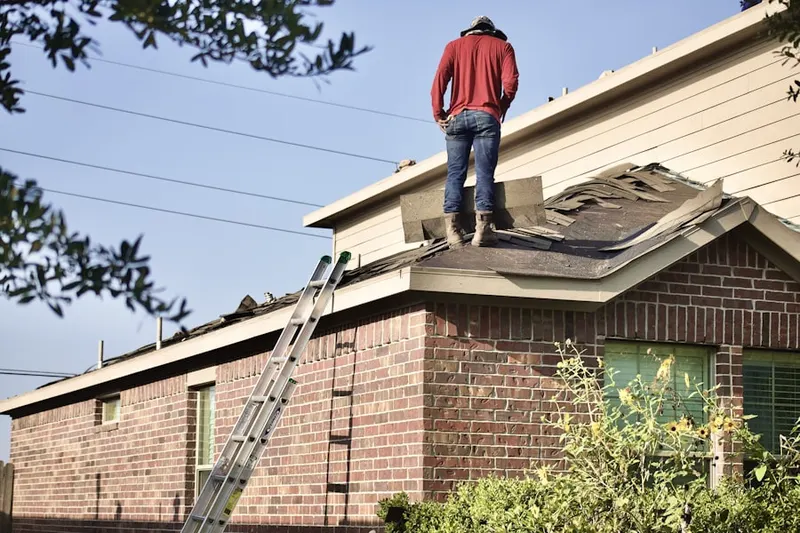 Professional roofer working on a residential roof in Worley